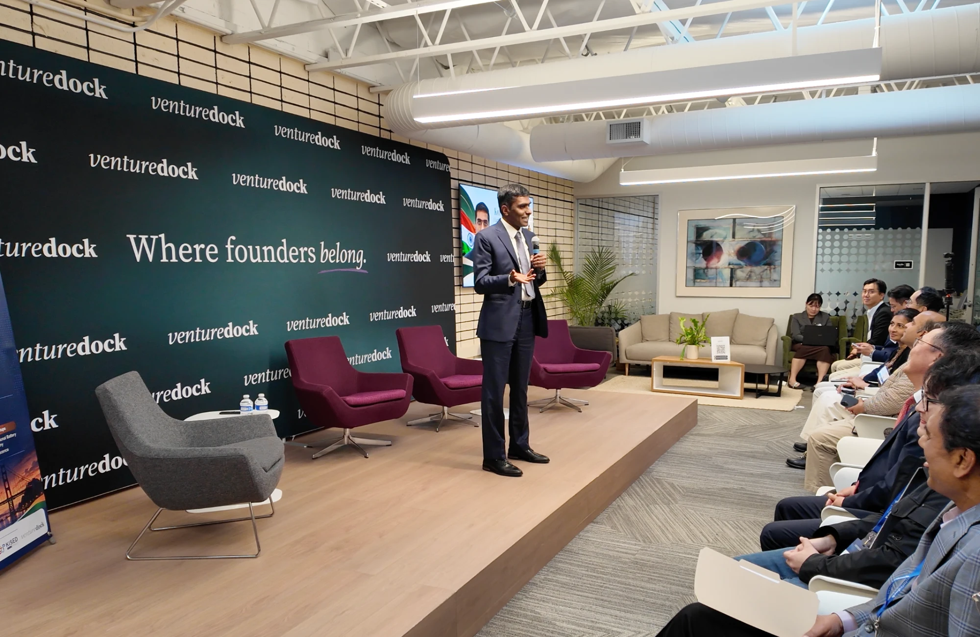 A speaker addresses founders and investors from the Venture Dock stage